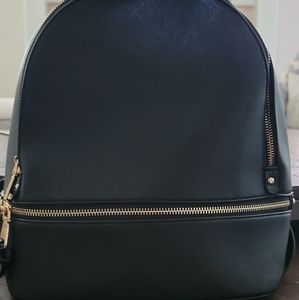 Black backpack purse with gold zippers